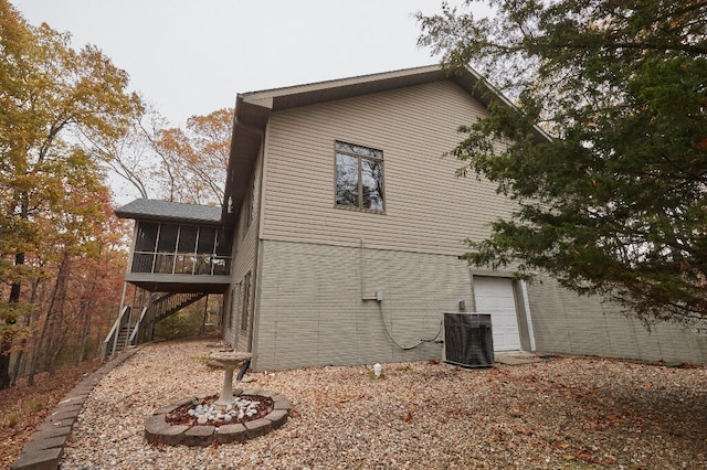 view of home's exterior featuring central AC unit and a sunroom