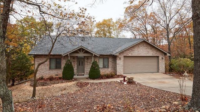 ranch-style house with a garage, brick siding, concrete driveway, and a shingled roof