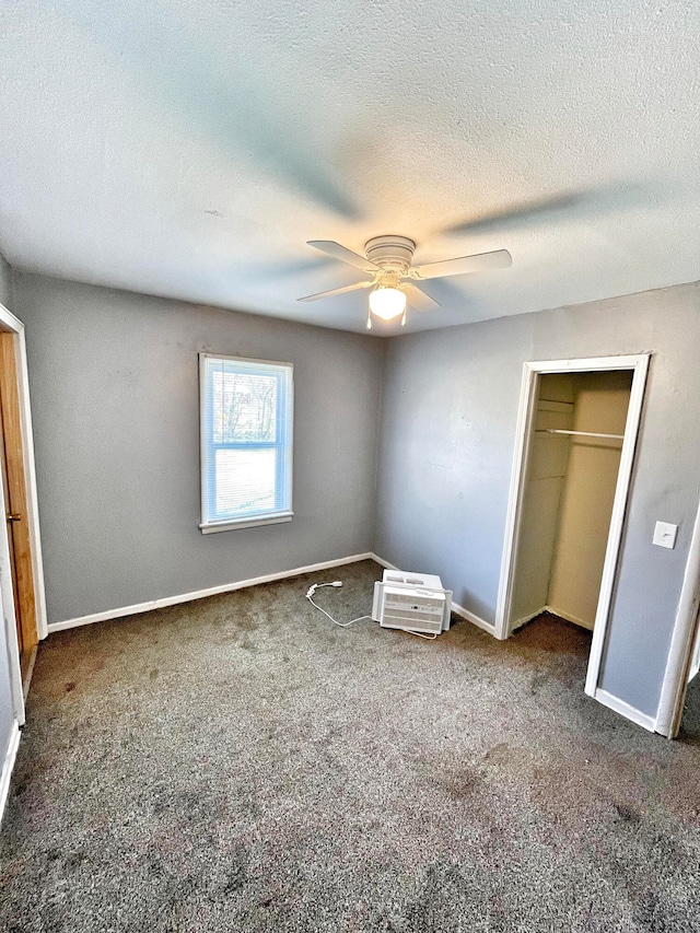 unfurnished bedroom featuring a textured ceiling, carpet floors, a ceiling fan, baseboards, and a closet