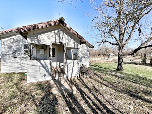 view of side of home featuring a yard