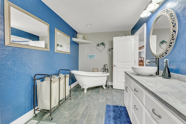 bathroom with a bathing tub, vanity, and wood-type flooring