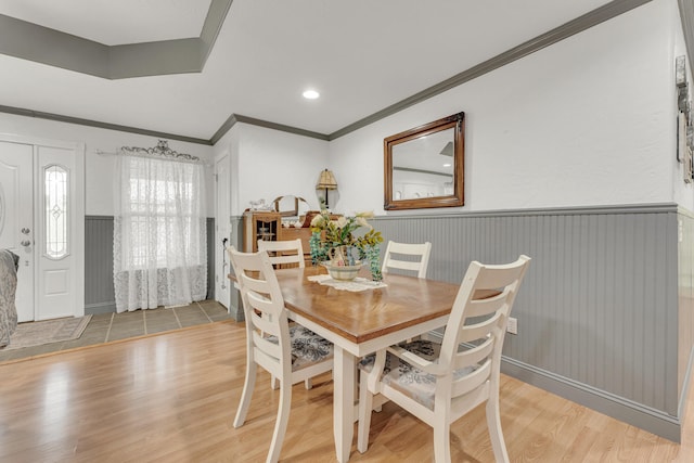 dining room featuring light hardwood / wood-style flooring and crown molding