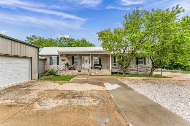 ranch-style house with covered porch and a garage