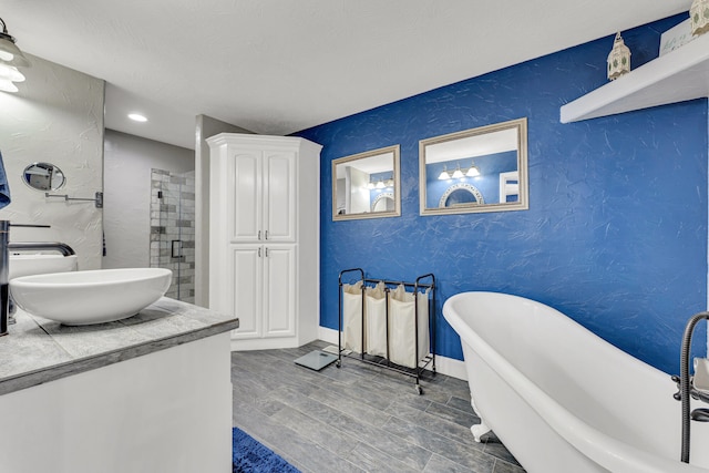 bathroom with hardwood / wood-style floors, vanity, and independent shower and bath