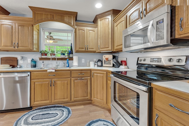 kitchen featuring sink, light hardwood / wood-style flooring, and appliances with stainless steel finishes