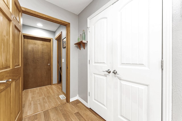 hall with light hardwood / wood-style flooring