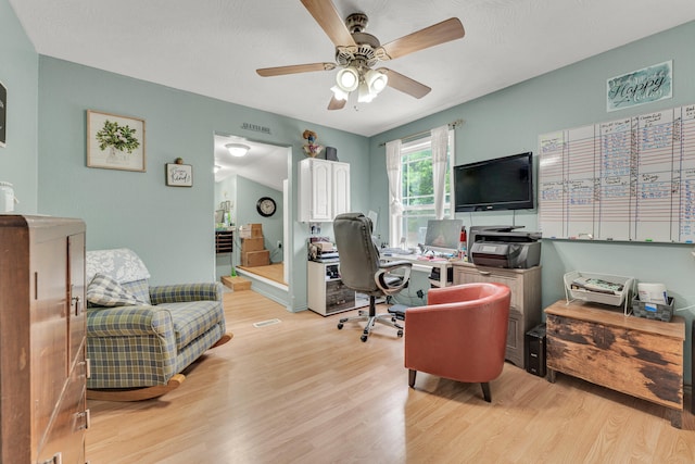 office with ceiling fan and light hardwood / wood-style flooring