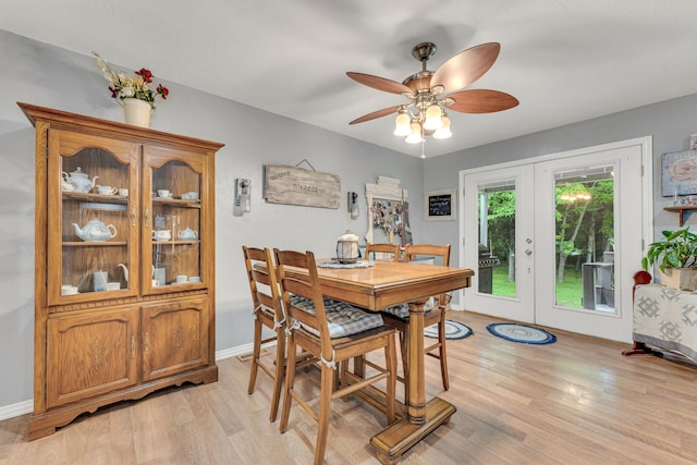 dining room with ceiling fan, french doors, and light wood-type flooring