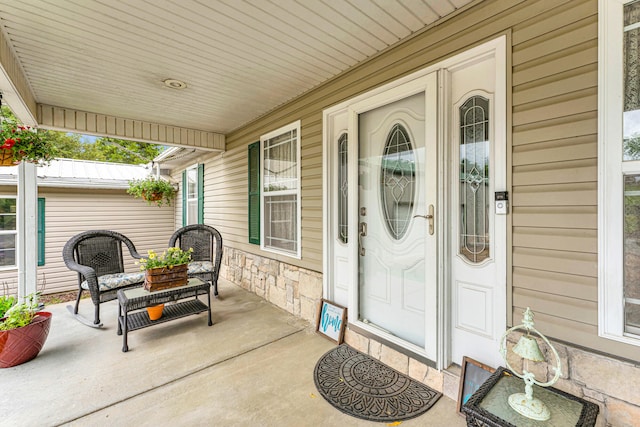 view of exterior entry featuring a porch