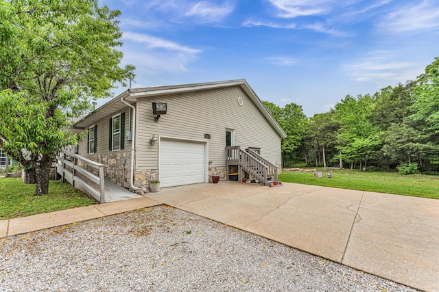 view of side of property featuring a yard and a garage