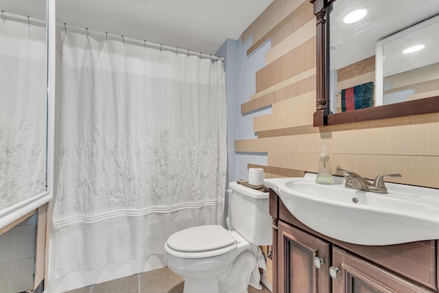 bathroom with a shower with shower curtain, vanity, toilet, and tile walls