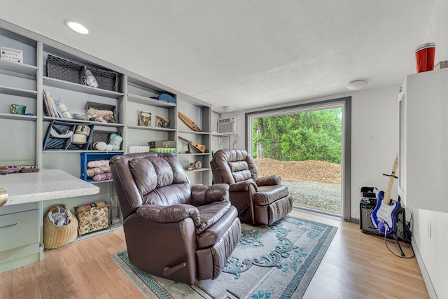 living room with a textured ceiling and light hardwood / wood-style flooring