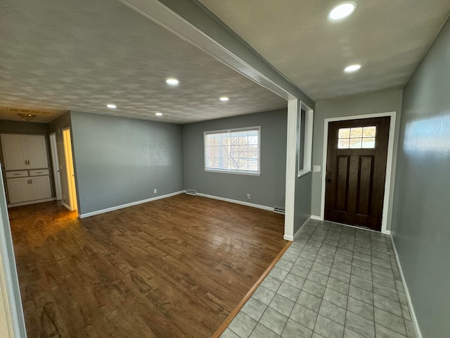 foyer entrance with plenty of natural light and light wood-type flooring