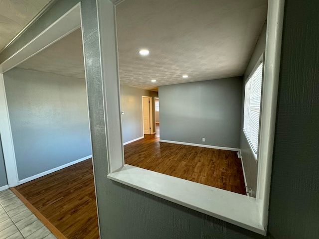 unfurnished room with hardwood / wood-style floors