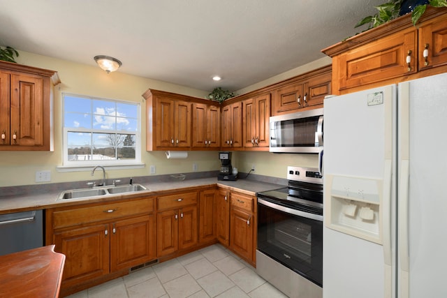 kitchen featuring sink, light tile patterned flooring, and appliances with stainless steel finishes