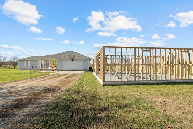 view of front of house featuring a front yard and a garage