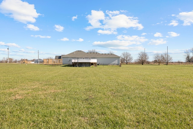 view of yard with a rural view and a wooden deck