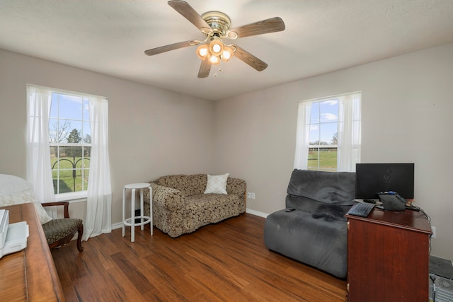 sitting room with ceiling fan and dark hardwood / wood-style floors