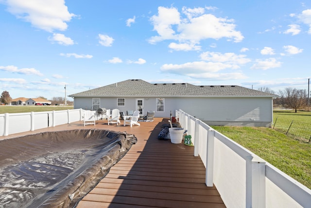 back of house with a lawn and a deck