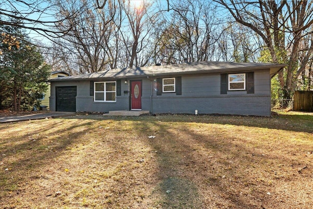 single story home with a front yard and a garage