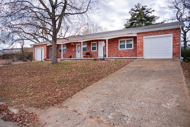 ranch-style home featuring covered porch and a garage