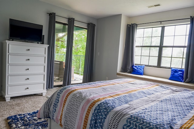 carpeted bedroom with access to outside