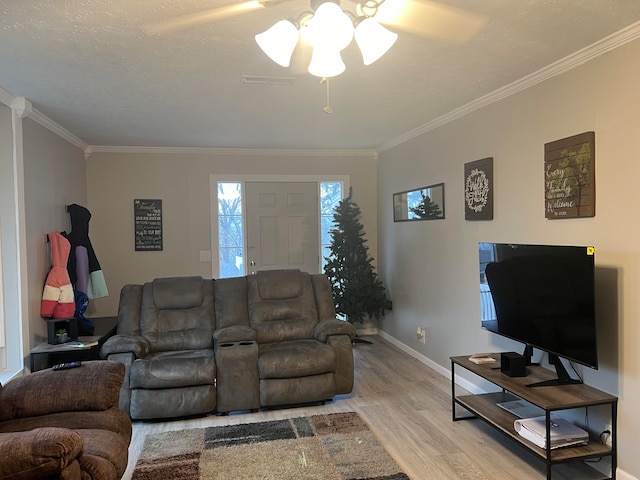 living room with ceiling fan, crown molding, and light hardwood / wood-style flooring