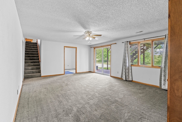 empty room featuring carpet, ceiling fan, and a wealth of natural light