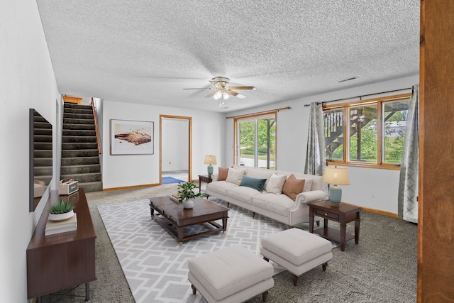 living room with carpet, a textured ceiling, a wealth of natural light, and ceiling fan