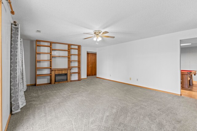 unfurnished living room with carpet, ceiling fan, a textured ceiling, and pool table