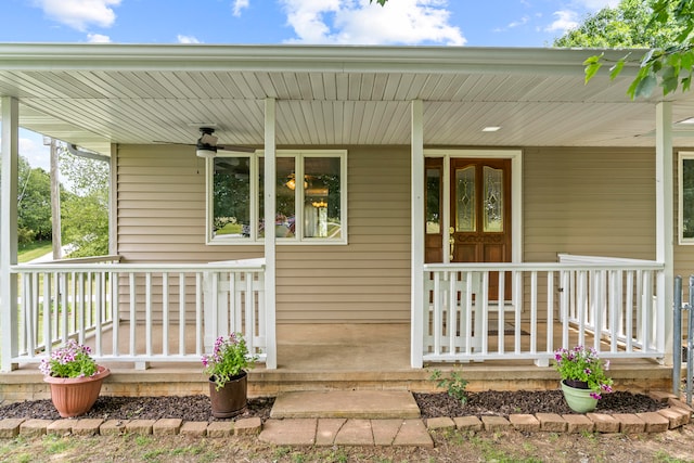 entrance to property with ceiling fan and a porch