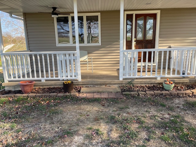 doorway to property featuring ceiling fan and a porch