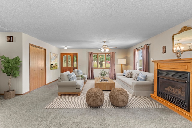 carpeted living room featuring ceiling fan and a textured ceiling