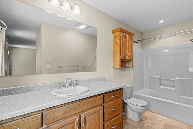 full bathroom featuring vanity, tile patterned floors, washtub / shower combination, toilet, and a textured ceiling