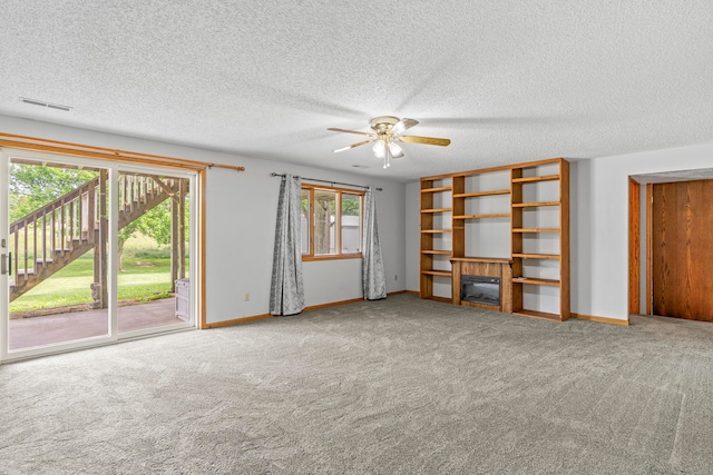 unfurnished living room with ceiling fan, carpet, and a textured ceiling