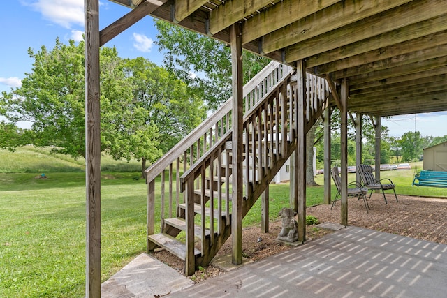 wooden terrace with a yard and a patio