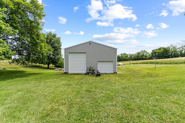 view of outbuilding with a garage and a yard