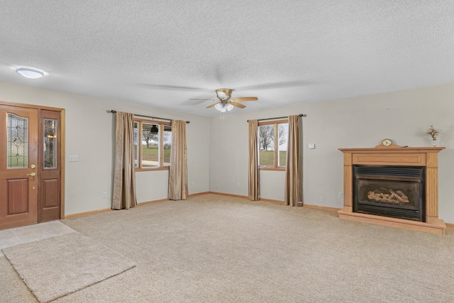 unfurnished living room with light carpet, ceiling fan, and a healthy amount of sunlight