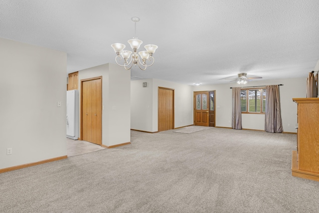 unfurnished living room with a textured ceiling, light carpet, and ceiling fan with notable chandelier