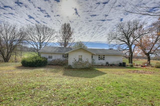 view of side of property with a yard