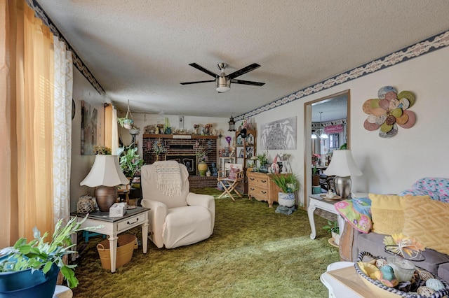 carpeted living room with ceiling fan, a fireplace, and a textured ceiling