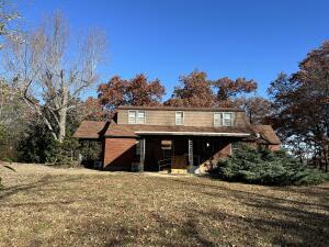 312 E Maple St, West Plains, MO 65775 - rear view of house with a yard