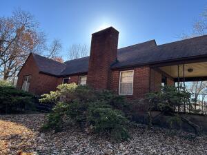 312 E Maple St, West Plains, MO 65775 - view of side of property with a chimney