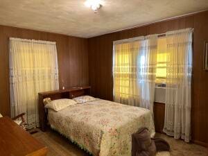 bedroom with wooden walls