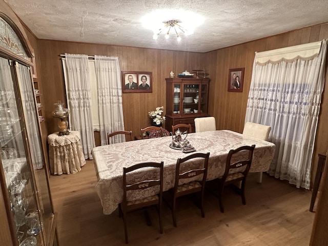 312 E Maple St, West Plains, MO 65775 - dining room with a textured ceiling, wood finished floors, and wood walls