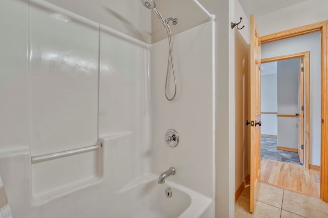 bathroom with hardwood / wood-style floors and shower / bath combination