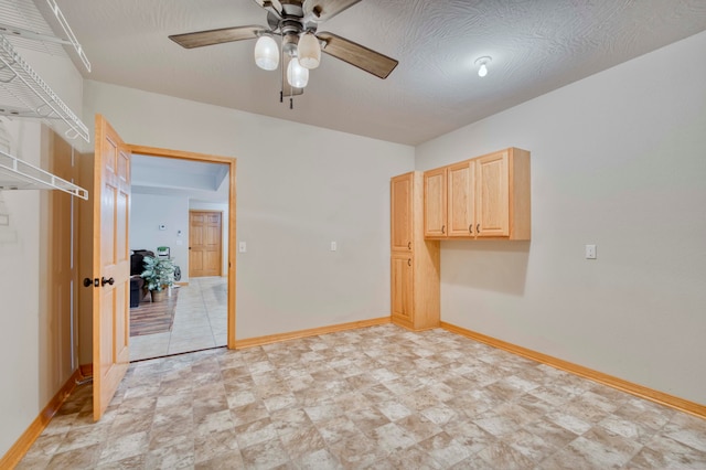 unfurnished room featuring ceiling fan and a textured ceiling