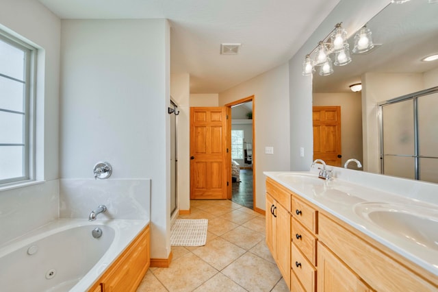 bathroom featuring tile patterned flooring, vanity, and separate shower and tub