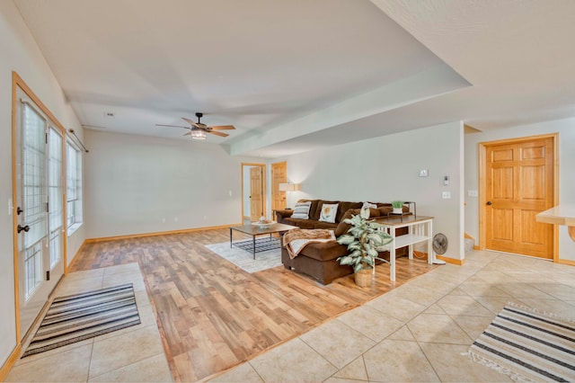 living room with ceiling fan and light hardwood / wood-style flooring