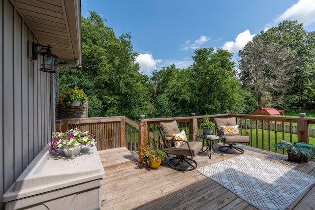 wooden terrace featuring a lawn